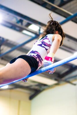Gymnast training on the bar at Auchterarder Gymnastics Club, an active Scottish Gymnastics membership club
